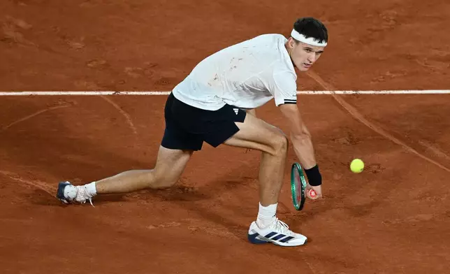Czech Republic's Jakub Mensik returns to Brazil's Joao Fonseca during the quarterfinal tennis match at the French Open in Paris, Tuesday, June 2, 2026. (AP Photo/Emma Da Silva)