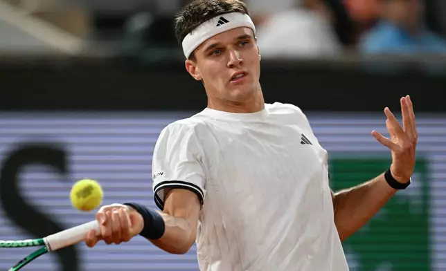Czech Republic's Jakub Mensik returns to Brazil's Joao Fonseca during the quarterfinal tennis match at the French Open in Paris, Tuesday, June 2, 2026. (AP Photo/Emma Da Silva)