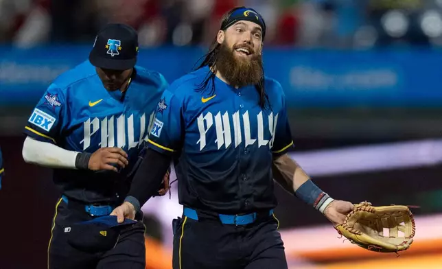 Philadelphia Phillies' Brandon Marsh, right, reacts after a baseball game against the Chicago White Sox, Friday, June 5, 2026, in Philadelphia. (AP Photo/Chris Szagola)