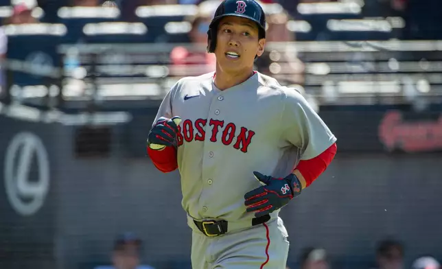 Boston Red Sox's Masataka Yoshida reacts after scoring on an RBI single by Isiahh Kiner-Falefa during the seventh inning of a baseball game against the Cleveland Guardians, Sunday, May 31, 2026, in Cleveland. (AP Photo/Phil Long)