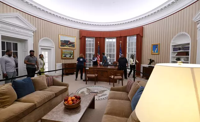 Visitors tour a replica of former President Barack Obama's oval office at the Obama Presidential Center in Chicago, Thursday, May 28, 2026. (AP Photo/Paul Beaty)