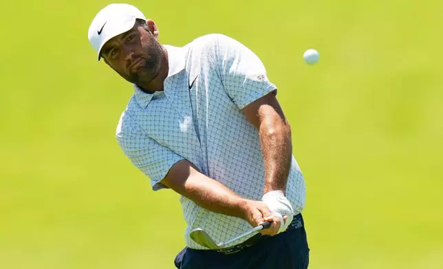 Scottie Scheffler chips to the green on the 12th hole during a practice round for the U.S. Open golf tournament at Shinnecock Hills Golf Club in Southampton, N.Y., Wednesday, June 17, 2026.(AP Photo/Seth Wenig)