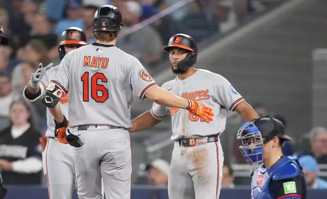 Baltimore Orioles' Coby Mayo (16) celebrates his home run with teammates against the Toronto Blue Jays during sixth inning of a baseball game in Toronto on Friday, June 5, 2026. (Nathan Denette/The Canadian Press via AP)
