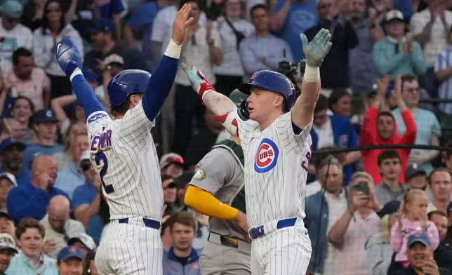 Chicago Cubs' Pete Crow-Armstrong, right, is greeted by Nico Hoerner, left after hitting a two-run home run against the Athletics during the third inning in a baseball game Wednesday, June 3, 2026, in Chicago. (AP Photo/David Banks)