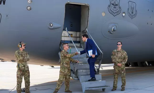 U.S. Secretary of State Marco Rubio greets crew members as he boards a U.S. Air Force C-17 Globemaster III transport aircraft at Bahrain International Airport after his visit to the Middle East, in Manama, Bahrain Thursday, June 25, 2026. (Eric Lee/Pool Photo via AP)