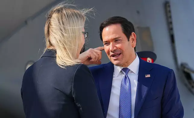 U.S. Secretary of State Marco Rubio, right, speaks with the U.S. Ambassador to Bahrain Stephanie Hallett before boarding a U.S. Air Force C-17 Globemaster III transport aircraft at Bahrain International Airport after his visit to the Middle East, in Manama, Bahrain Thursday, June 25, 2026. (Eric Lee/Pool Photo via AP)