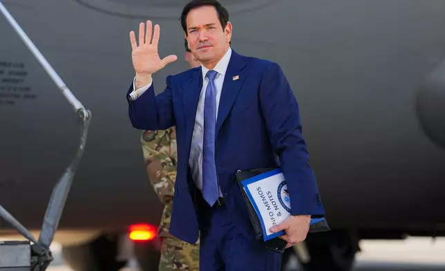U.S. Secretary of State Marco Rubio waves as he boards a U.S. Air Force C-17 Globemaster III transport aircraft at Bahrain International Airport after his visit to the Middle East, in Manama, Bahrain Thursday, June 25, 2026. (Eric Lee/Pool Photo via AP)