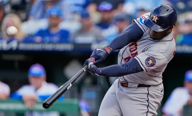 Houston Astros' Yordan Alvarez hits a two-run home run hit during the first inning of a baseball game against the Kansas City Royals, Friday, June 12, 2026, in Kansas City, Mo. (AP Photo/Charlie Riedel)