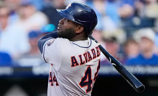 Houston Astros' Yordan Alvarez watches his grand slam during the first inning of a baseball game against the Kansas City Royals, Friday, June 12, 2026, in Kansas City, Mo. (AP Photo/Charlie Riedel)