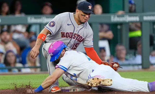 Kansas City Royals' Kameron Misner is tagged out on third by Houston Astros third baseman Isaac Paredes (15) as he tried to advance on a single by Isaac Collins during the first inning of a baseball game Friday, June 12, 2026, in Kansas City, Mo. (AP Photo/Charlie Riedel)