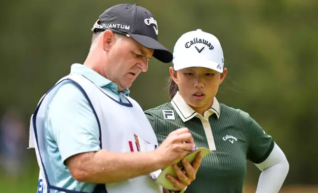 Ruoning Yin, of China, talks with her caddie on the sixth hole during the second round of the U.S. Women's Open golf tournament Friday, June 5, 2026, in the Pacific Palisades area of Los Angeles. (AP Photo/Ashley Landis)
