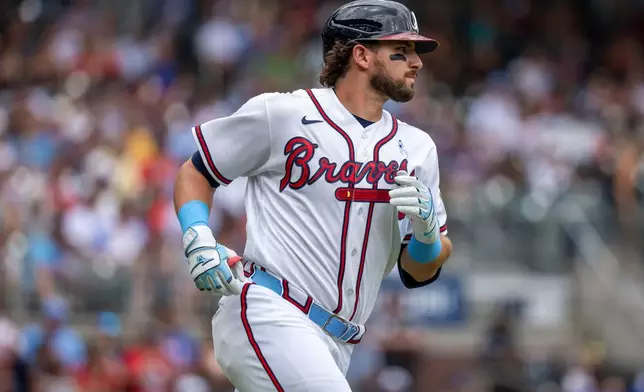 Atlanta Braves third baseman Austin Riley runs to first on a base hit during the second inning of a baseball game against the Milwaukee Brewers, Sunday, June 21, 2026, in Atlanta. (AP Photo/Erik Rank)