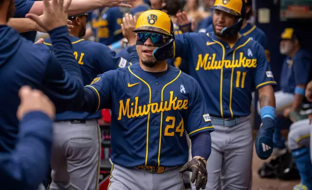 Milwaukee Brewers' William Contreras (24) celebrates after batting in three runs during the second inning of a baseball game against the Atlanta Braves, Sunday, June 21, 2026, in Atlanta. (AP Photo/Erik Rank)