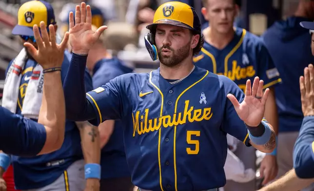 Milwaukee Brewers' Garrett Mitchell (5) celebrates after stealing home during the seventh inning of a baseball game against the Atlanta Braves, Sunday, June 21, 2026, in Atlanta. (AP Photo/Erik Rank)
