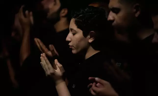 Iranians perform their evening prayers in a mourning ceremony in Tehran, Iran, Tuesday, June 23, 2026, prior to Ashoura, which commemorates the 7th-century martyrdom of Imam Hussein, one of Prophet Muhammad's grandsons and one of Shiite Islam's most beloved saints, and 72 of his companions, who were killed in a battle in Karbala in present-day Iraq. (AP Photo/Vahid Salemi)