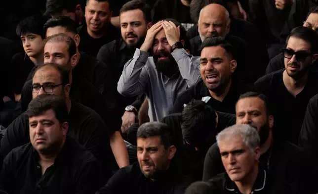 People weep during a mourning ceremony in Tehran, Iran, Thursday, June 18, 2026, ahead of Ashoura, which honors the 7th-century martyrdom of the Prophet Muhammad's grandson, Hussein, who was killed in a battle in Karbala in present-day Iraq. (AP Photo/Vahid Salemi)