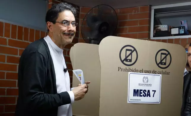 Presidential candidate Ivan Cepeda of the ruling Historic Pact coalition marks his ballot during the presidential election in Bogota, Colombia, Sunday, May 31, 2026. (AP Photo/John Vizcaino)