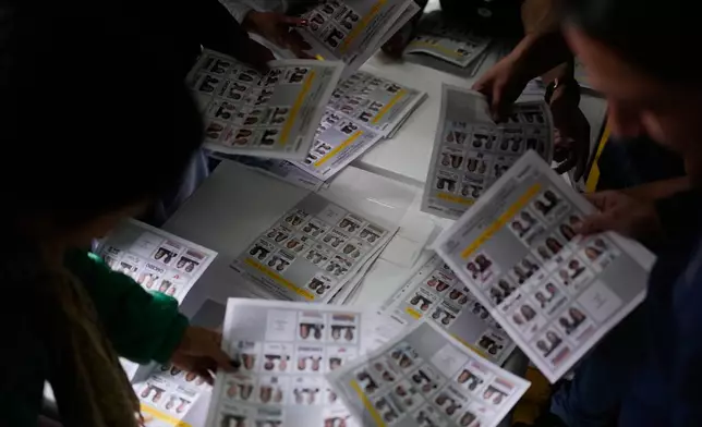 Election officials count ballots after polls closed during the presidential election in Bogota, Colombia, Sunday, May 31, 2026. (AP Photo/Matias Delacroix)