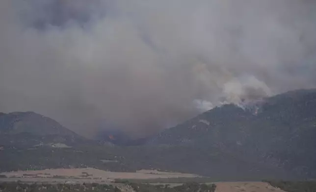 Smoke rises from the Cottonwood Fire near Beaver, Uta, on Friday, June 26, 2026. (AP Photo/Ty ONeil)