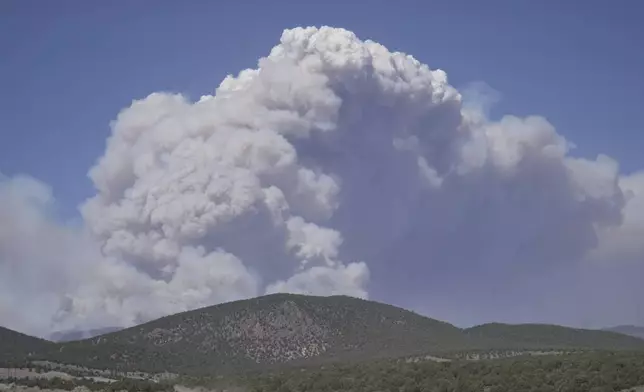 A plume of smoke rises from the Cottonwood Fire, Friday, June 26, 2026, near Beaver, Utah. (AP Photo/Ty ONeil)