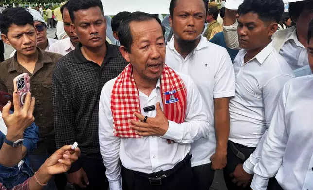 Rong Chhun, a top adviser to the Nation Power Party and a prominent opposition politician, stands with supporters outside Cambodia's Supreme Court in Phnom Penh, Friday, June 19, 2026. (AP Photo/Sopheng Cheang)