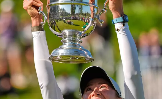 Nelly Korda holds up the trophy after winning the U.S. Women's Open golf tournament Sunday, June 7, 2026, in the Pacific Palisades area of Los Angeles. (AP Photo/Ashley Landis)