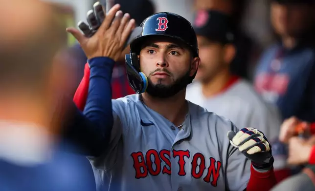Boston Red Sox Wilyer Abreu celebrates after scoring on a wild pitch by Seattle Mariners pitcher José A. Ferrer in the sixth inning of a baseball game Saturday, June 20, 2026, in Seattle. (AP Photo/Kevin Ng)