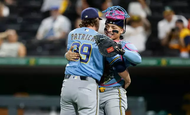 Milwaukee Brewers relief pitcher Chad Patrick (39) and catcher William Contreras (24) following the Brewers' victory over the Athletics Monday, June 8, 2026, in Las Vegas. (AP Photo/Caroline Brehman)