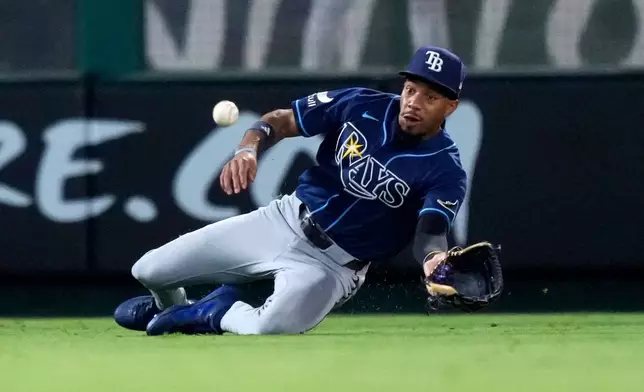 Tampa Bay Rays left fielder Chandler Simpson can't handle a ball hit for a single by Los Angeles Angels' Denzer Guzman during the seventh inning of a baseball game Saturday, June 13, 2026, in Anaheim, Calif. (AP Photo/Mark J. Terrill)