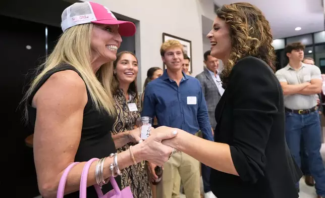 FILE - U.S. Senate candidate Rep. Julia Letlow, R-La., right, speaks with supporters during an election night watch party, May 16, 2026, in Baton Rouge, La. (AP Photo/Matthew Hinton, File)