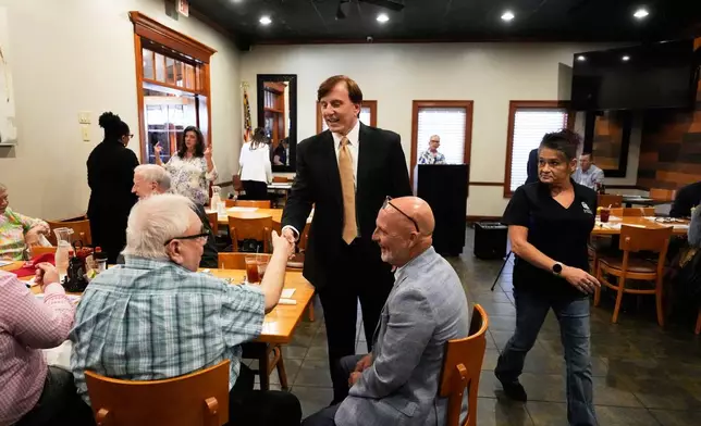 FILE - John Fleming, a U.S. Senate candidate, current Louisiana treasurer and former Republican House representative of Louisiana, greets supporters at a Ronald Reagan Newsmaker Luncheon in Baton Rouge, La., May 12, 2026. (AP Photo/Gerald Herbert, File)