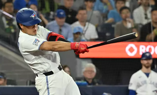 Toronto Blue Jays' Kazuma Okamoto hits a double against the Houston Astros during the seventh inning of a baseball game in Toronto, Monday, June 22, 2026. (Jon Blacker/The Canadian Press via AP)
