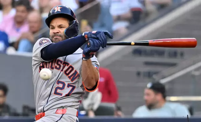 Houston Astros' Jose Altuve fouls off a pitch during the first inning of a baseball game against the Toronto Blue Jays, in Toronto, Monday, June 22, 2026. (Jon Blacker/The Canadian Press via AP)