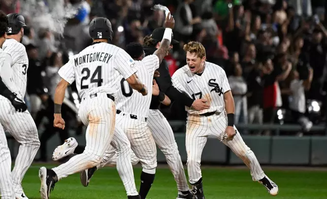 Chicago White Sox's Sam Antonacci, right, celebrates with teammates after he hit a two-run single during the ninth inning of a baseball game against the Cleveland Guardians, Monday, June 22, 2026, in Chicago. (AP Photo/Matt Marton)