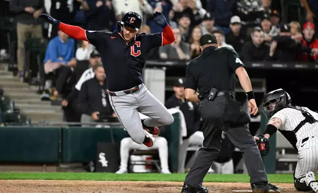 Cleveland Guardians' Patrick Bailey, left, scores past Chicago White Sox catcher Kyle Teel, right, during the ninth inning of a baseball game, Monday, June 22, 2026, in Chicago. (AP Photo/Matt Marton)