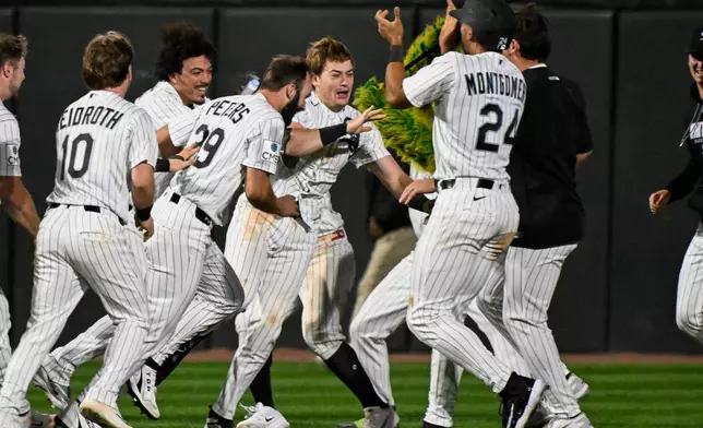Chicago White Sox's Sam Antonacci, center, celebrates with teammates after he hit a two-run single during the ninth inning of a baseball game against the Cleveland Guardians, Monday, June 22, 2026, in Chicago. (AP Photo/Matt Marton)