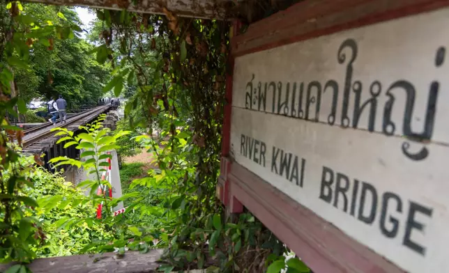 Visitors walk along the River Kwai Bridge, one of the well-known sections of the infamous World War II "Death Railway," in Kanchanaburi, Thailand on Thursday, May 28, 2026. (AP Photo/Anton L. Delgado)