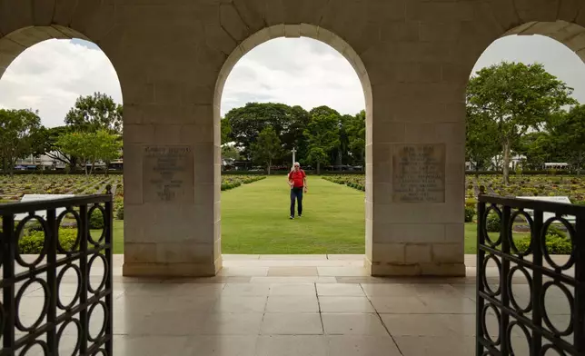 A visitor walks through the Don-Rak War Cemetary for the prisoners of war who died building the infamous World War II "Death Railway," in Kanchanaburi, Thailand, Sunday, May 31, 2026. (AP Photo/Anton L. Delgado)