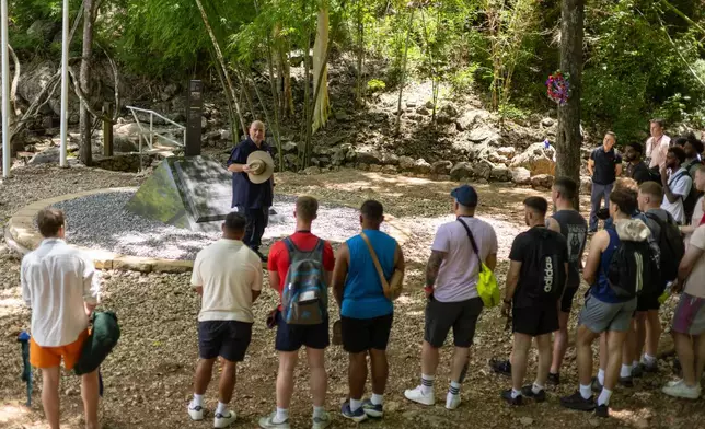 Mick Clarke, the manager of the Hellfire Pass Interpretive Centre, speaks to visitors at the infamous section of the World War II "Death Railway," in Sai Yok, Thailand, Sunday, May 31, 2026. (AP Photo/Anton L. Delgado)