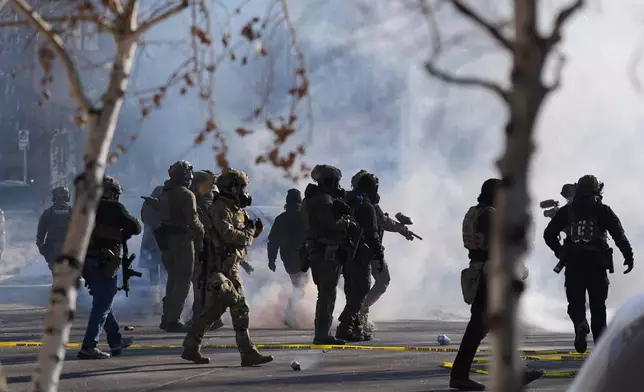 FILE - Federal immigration officers deploy tear gas at protesters after a shooting Jan. 24, 2026, in Minneapolis. (AP Photo/Abbie Parr, File)