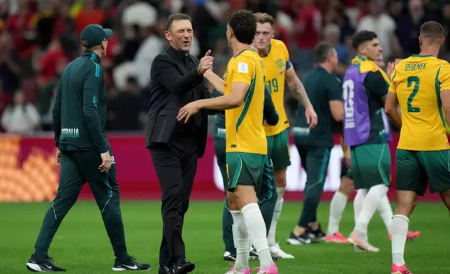 Australia's Tony Popovic, second left and Australia's Alessandro Circati celebrate following the World Cup Group D soccer match between Australia and Turkey in Vancouver, Canada, Saturday, June 13, 2026. (Darryl Dyck/The Canadian Press via AP)