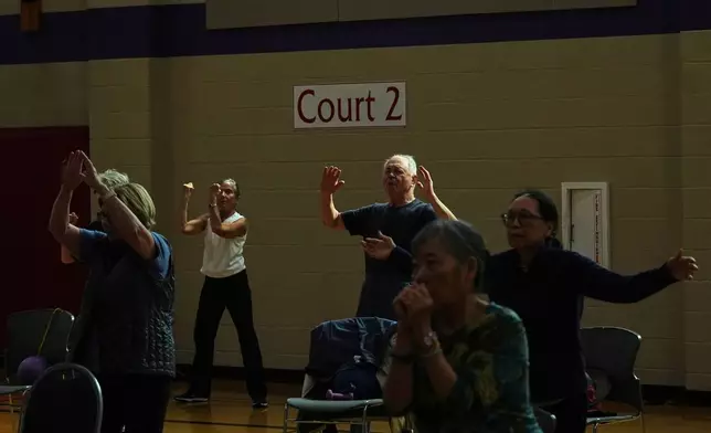 Participants do arm exercises in a class for older adults led by instructor Bengie Santos, 72, at the Dale Turner Family YMCA, April 30, 2026, in Shoreline, Wash. (AP Photo/Lindsey Wasson)