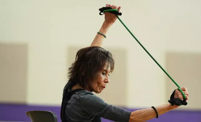 Instructor Bengie Santos, 72, leads a class for older adults at the Dale Turner Family YMCA, April 30, 2026, in Shoreline, Wash. (AP Photo/Lindsey Wasson)