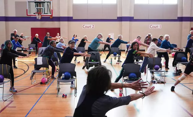 Instructor Bengie Santos, 72, at front, leads an exercise class for older adults at the Dale Turner Family YMCA, April 30, 2026, in Shoreline, Wash. (AP Photo/Lindsey Wasson)