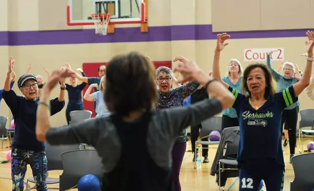 From left, Ann Kashiwa, Alma Alvarez-Smith and Pilar Madayag follow instructor Bengie Santos, 72, as she leads an exercise class for older adults at the Dale Turner Family YMCA, April 30, 2026, in Shoreline, Wash. (AP Photo/Lindsey Wasson)
