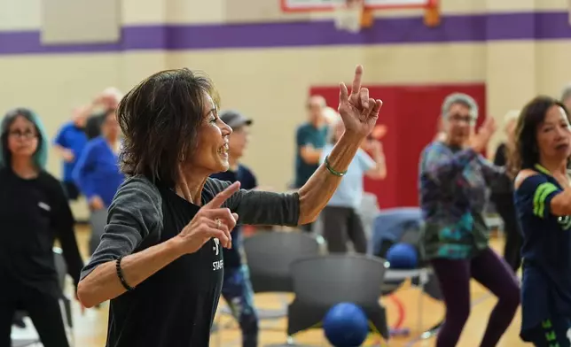 Instructor Bengie Santos, 72, leads a class for older adults at the Dale Turner Family YMCA, April 30, 2026, in Shoreline, Wash. (AP Photo/Lindsey Wasson)
