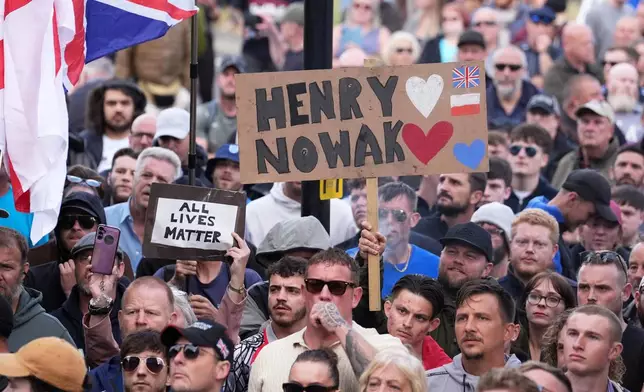 People gather to protest outside Southampton police station, Southampton, England, Tuesday June 2, 2026, after the fatal stabbing of Henry Nowak, a British teenager who was handcuffed despite claiming he was the crime victim. (Gareth Fuller/PA via AP)