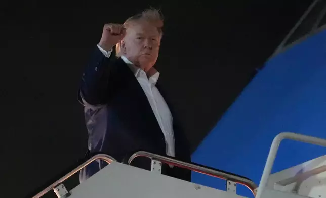 President Donald Trump gestures as he boards Air Force One, Monday, June 15, 2026, at Joint Base Andrews, Md. (AP Photo/Julia Demaree Nikhinson)