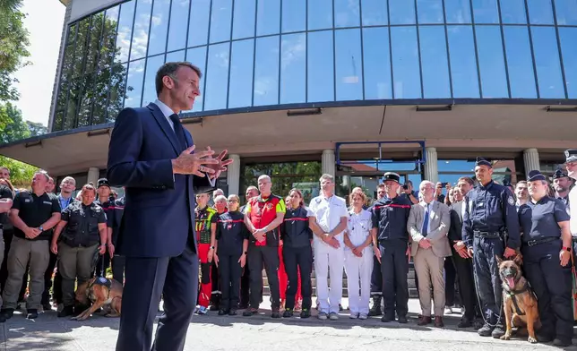 French President Emmanuel Macron meets members of the emergency forces, ahead of the G7 Summit, in Evian-les-Bains, France, Monday, June 15, 2026. (Christian Hartmann/Pool Photo via AP)