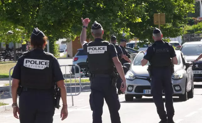 France Police officers control cars at a check point ahead of the G7 summit in Evian-les-Bains, France, Monday, June 15, 2026. (AP Photo/Christophe Ena)